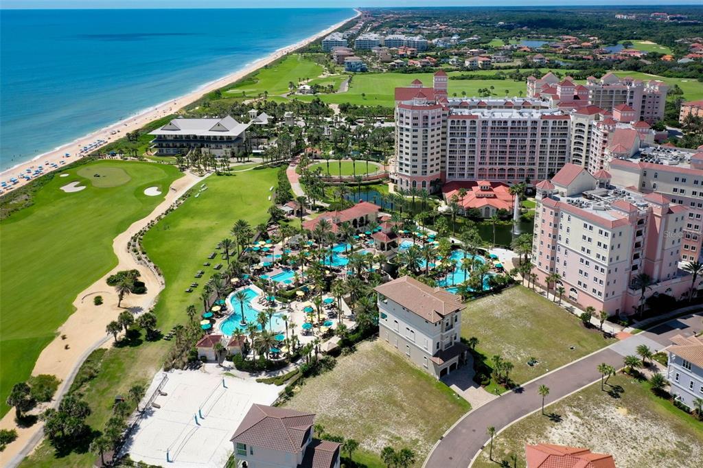 Aerial view of a large resort complex with a pool, golf course, and beach — 200 OCEAN CREST DRIVE UNIT 913, PALM COAST, FL