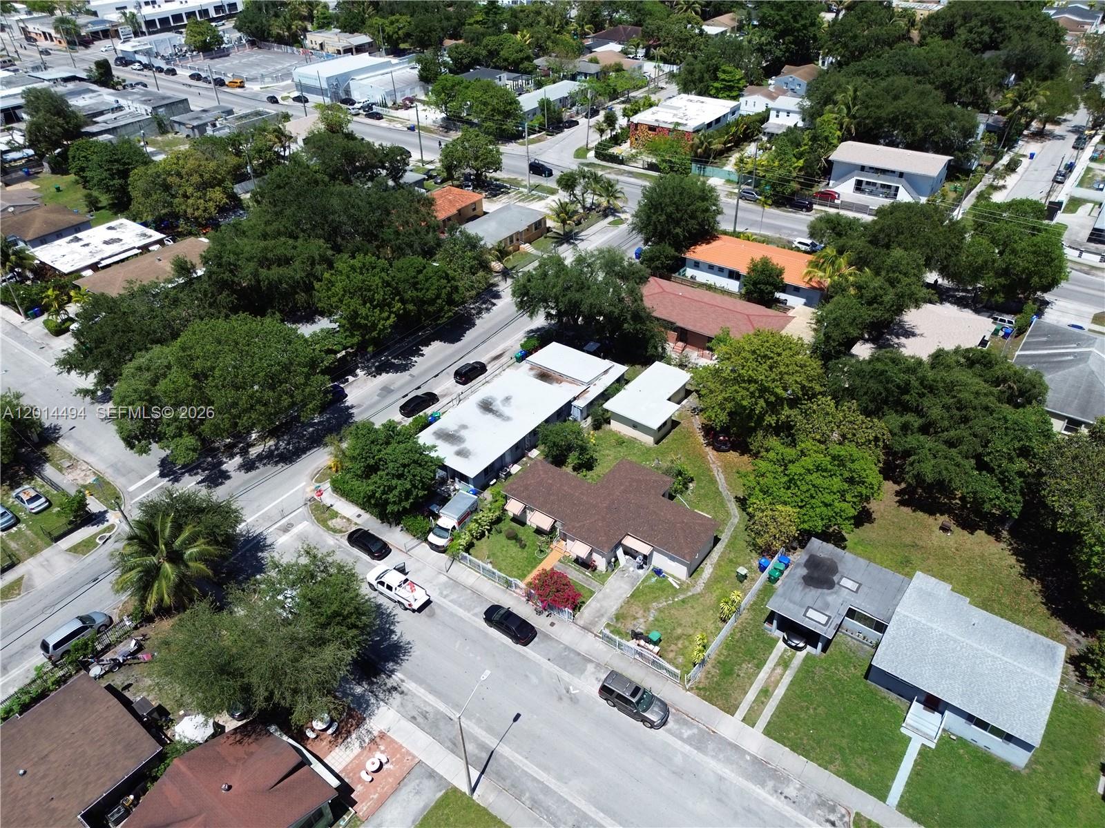 An aerial view shows a residential neighborhood with houses, trees, and parked cars on streets — 248 NW 69th St # 3, Miami FL 33150, MIAMI, FL