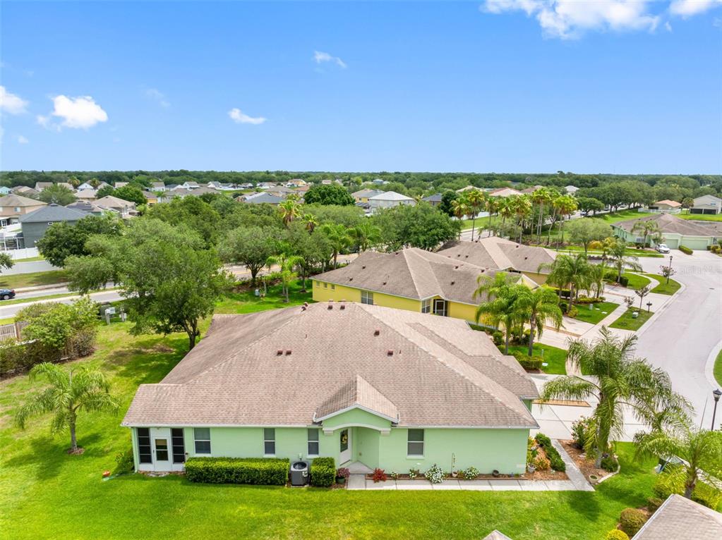 An aerial view shows a light green house with a brown roof and surrounding landscaping — 11588 CAPTIVA KAY DRIVE, RIVERVIEW, FL