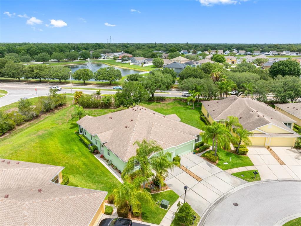 An aerial view shows a light green house with a shingled roof and driveway — 11588 CAPTIVA KAY DRIVE, RIVERVIEW, FL
