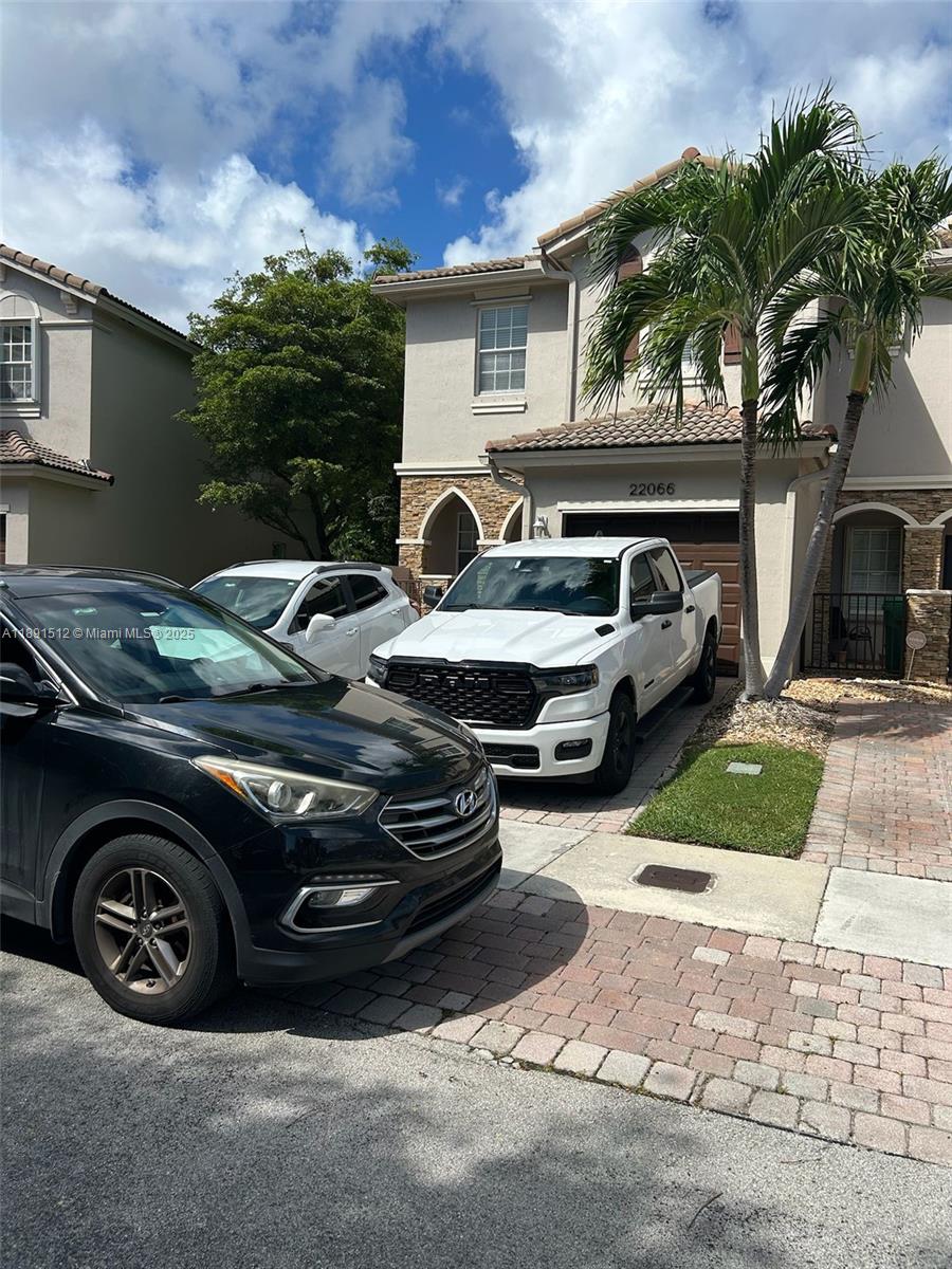 A two-story house exterior features a white truck parked in the driveway and palm trees — 22066 SW 93rd Pl, Cutler Bay FL 33190, CUTLER BAY, FL