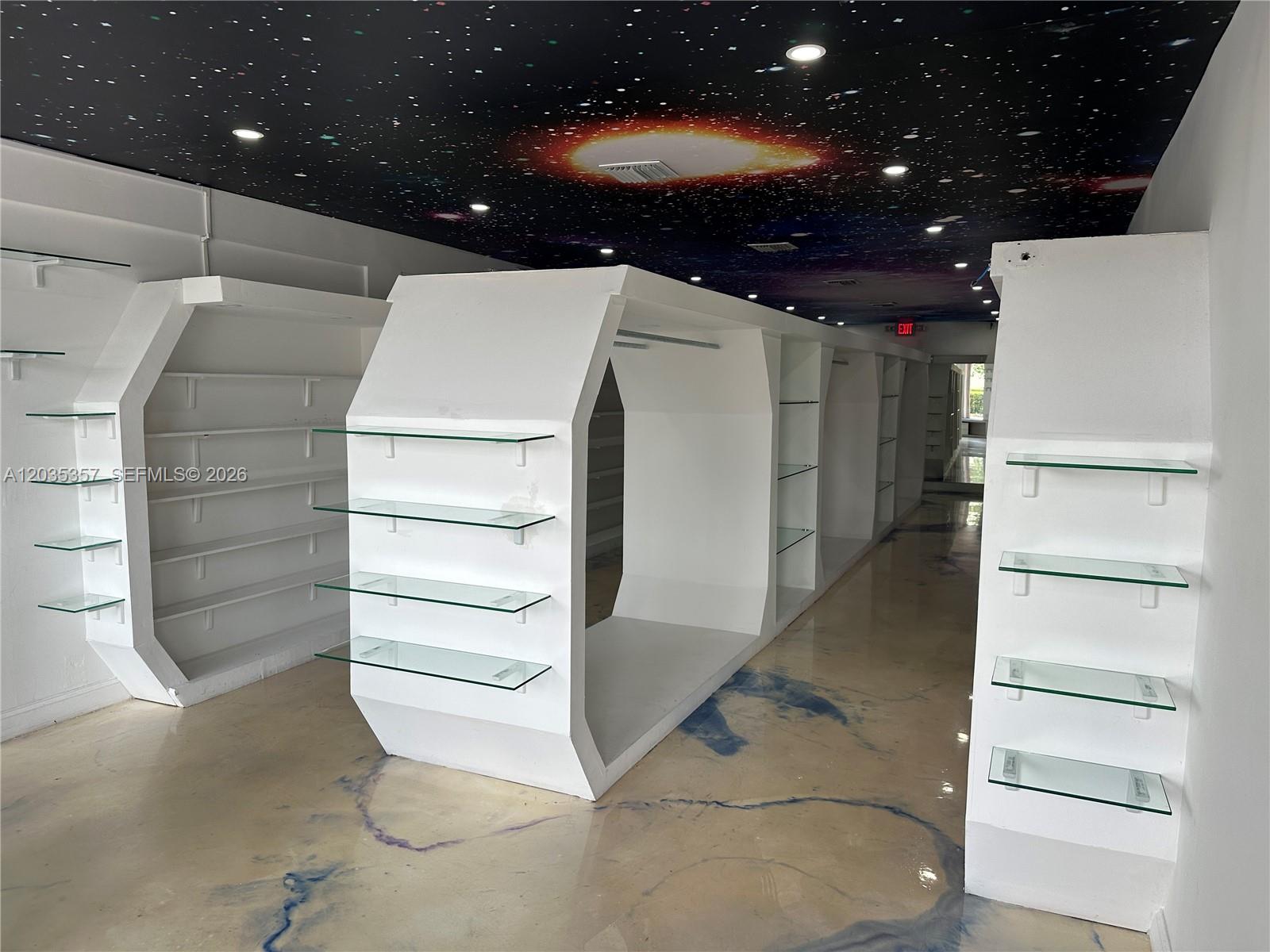 A retail space features white hexagonal shelving units and a ceiling painted with a galaxy mural — 142 Hialeah Dr, Hialeah FL 33010, HIALEAH, FL