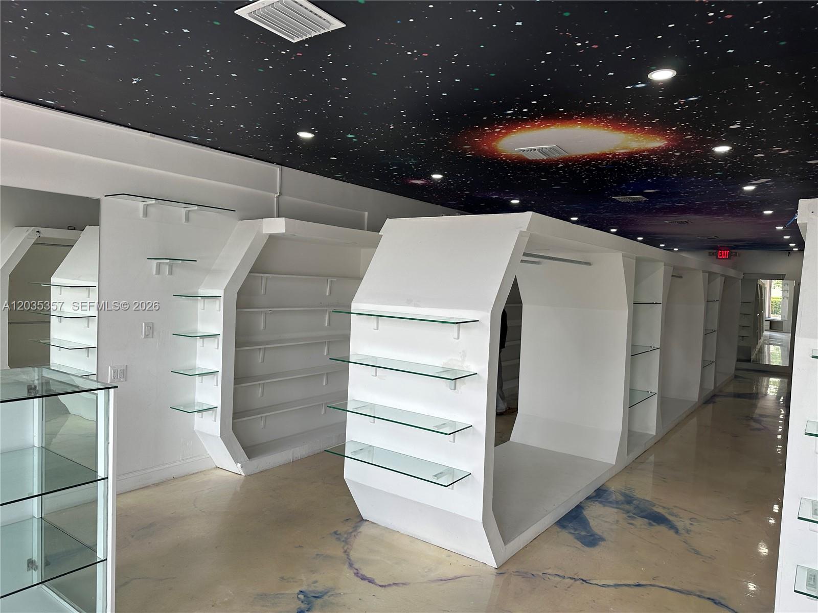 A retail space features custom white shelving units and a ceiling painted like outer space — 142 Hialeah Dr, Hialeah FL 33010, HIALEAH, FL
