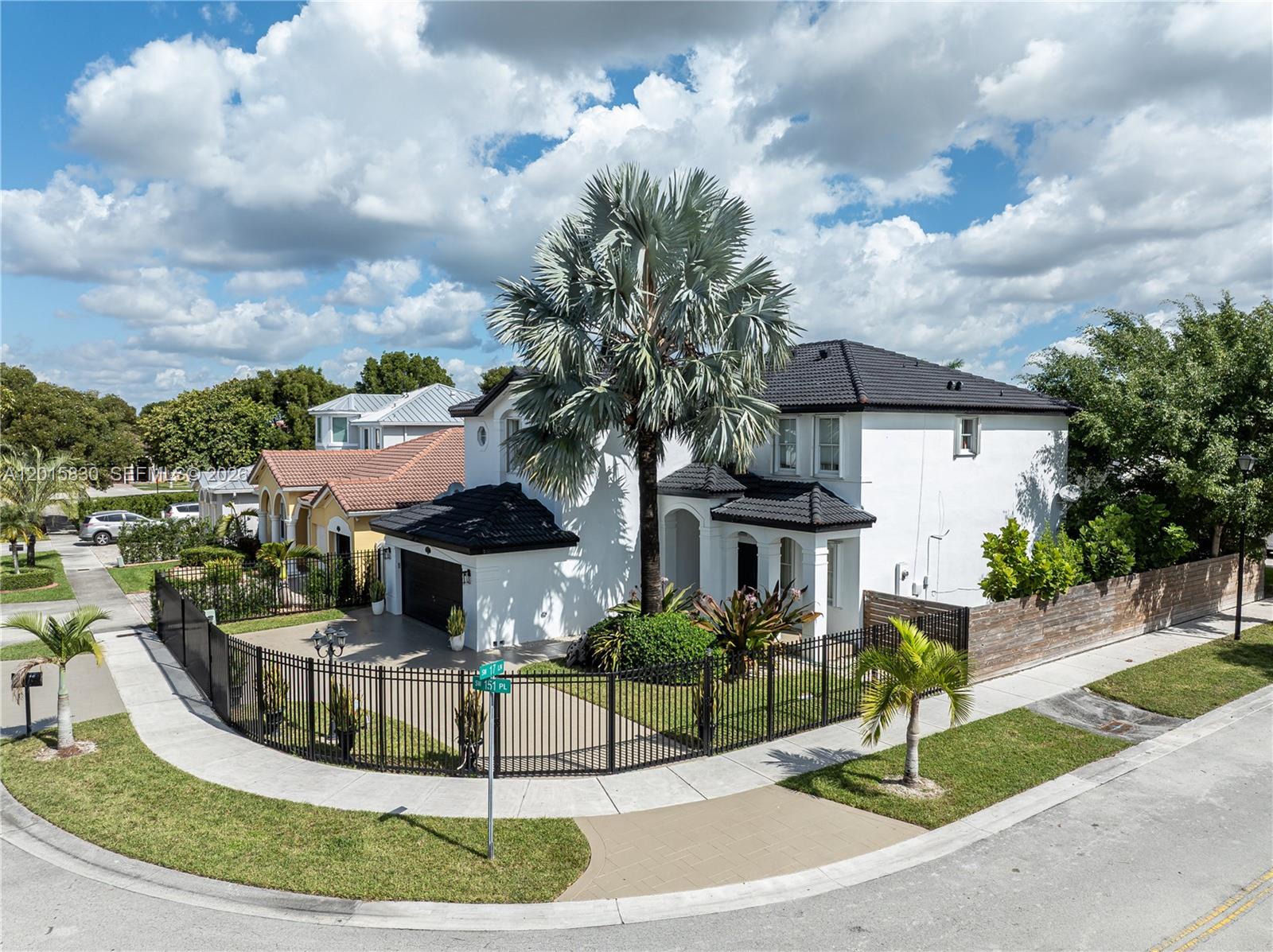 A two-story white house with a black tile roof sits on a corner lot — 1733 SW 151st Pl, Miami FL 33185, MIAMI, FL