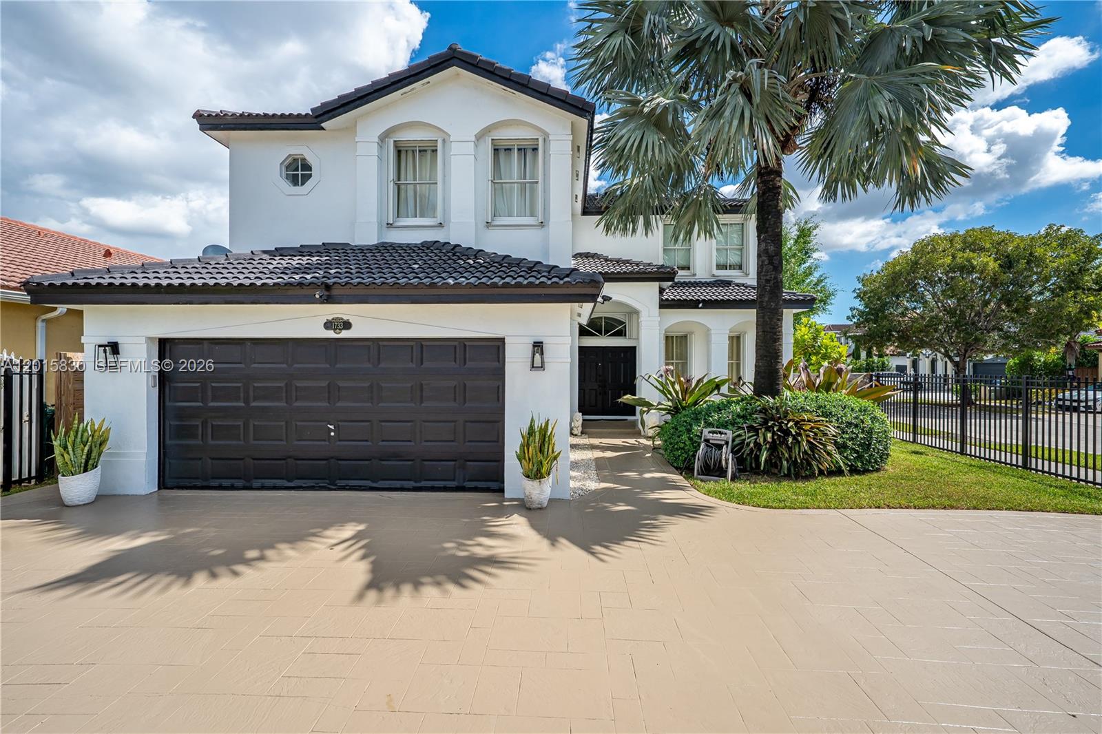 A two-story white house features a dark tile roof, a double garage, and a palm tree — 1733 SW 151st Pl, Miami FL 33185, MIAMI, FL