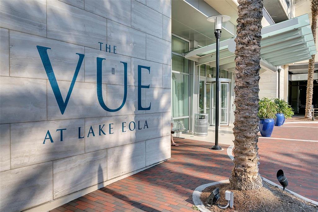 The exterior entrance of a building features a stone wall with the name The Vue — 150 E ROBINSON STREET UNIT 2709, ORLANDO, FL