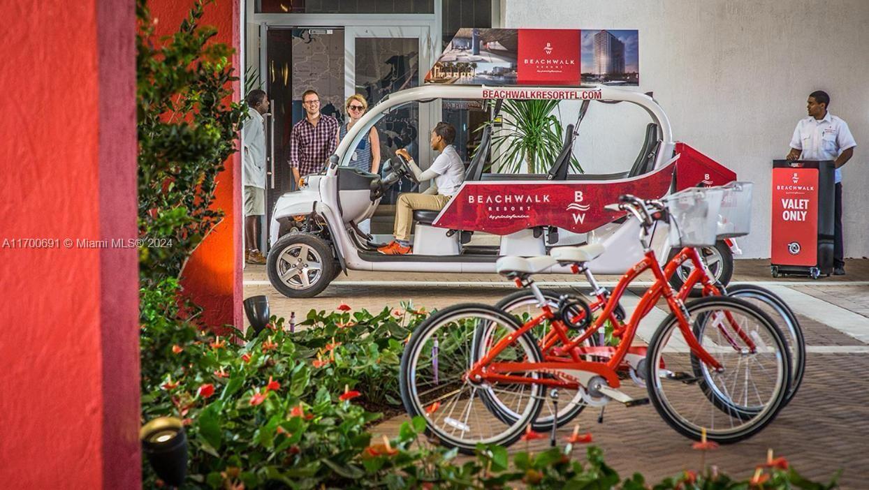 A resort shuttle vehicle is parked near a valet stand with bicycles in the foreground — 2602 E Hallandale Beach Blvd # R508, Hallandale Beach FL 33009, HALLANDALE BEACH, FL