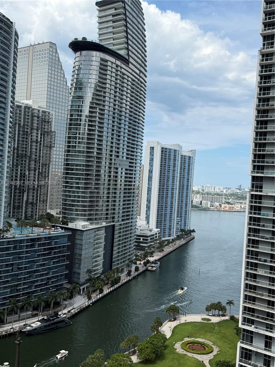 An elevated view of a canal surrounded by modern high-rise residential buildings and greenery — 500 Brickell Ave # 2907, Miami FL 33131, MIAMI, FL