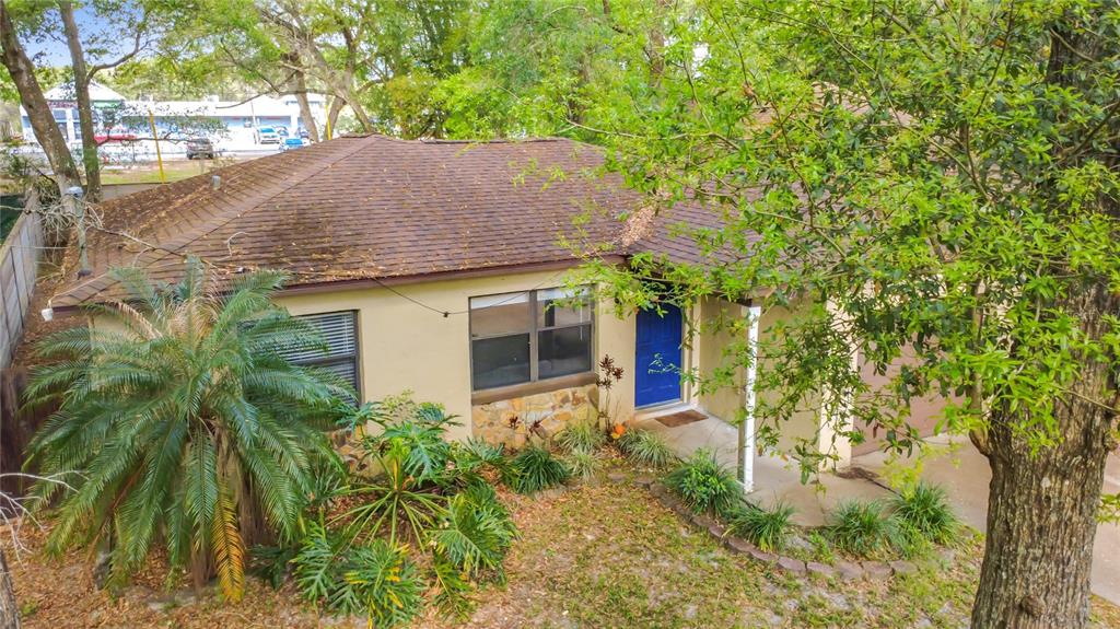 An elevated view of a single-story house with a brown roof and a blue door — 31427 GHENT AVENUE, MOUNT PLYMOUTH, FL