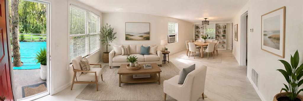 A bright, open-concept living and dining area with white walls, tile floors, and outdoor access — 1735 TIMOCUAN WAY UNIT A, LONGWOOD, FL