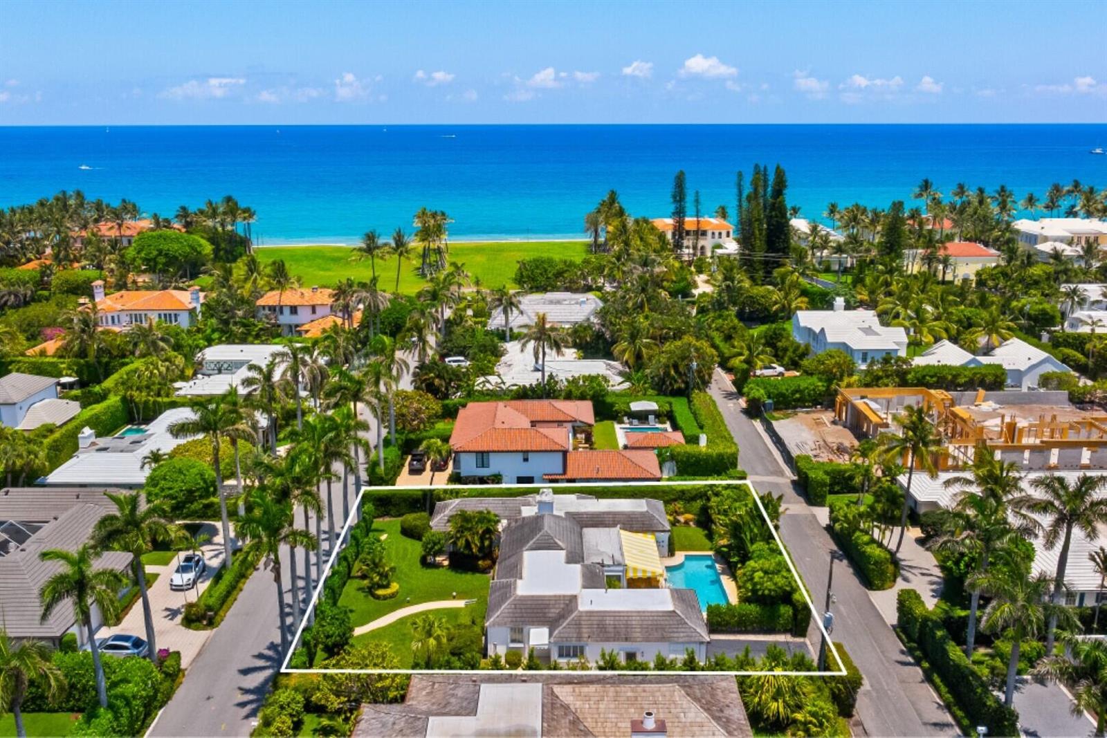 An aerial view shows a residential property with a swimming pool and lawn near the ocean — 226 List Road, Palm Beach FL 33480, PALM BEACH, FL