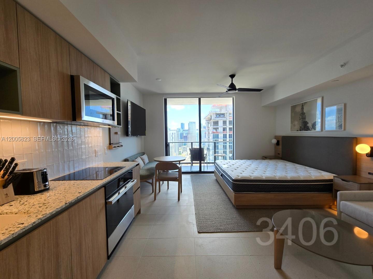 A studio apartment features a kitchen, dining area, bed, and balcony with city views — 601 NE 1 Ave # 3406, Miami FL 33132, MIAMI, FL