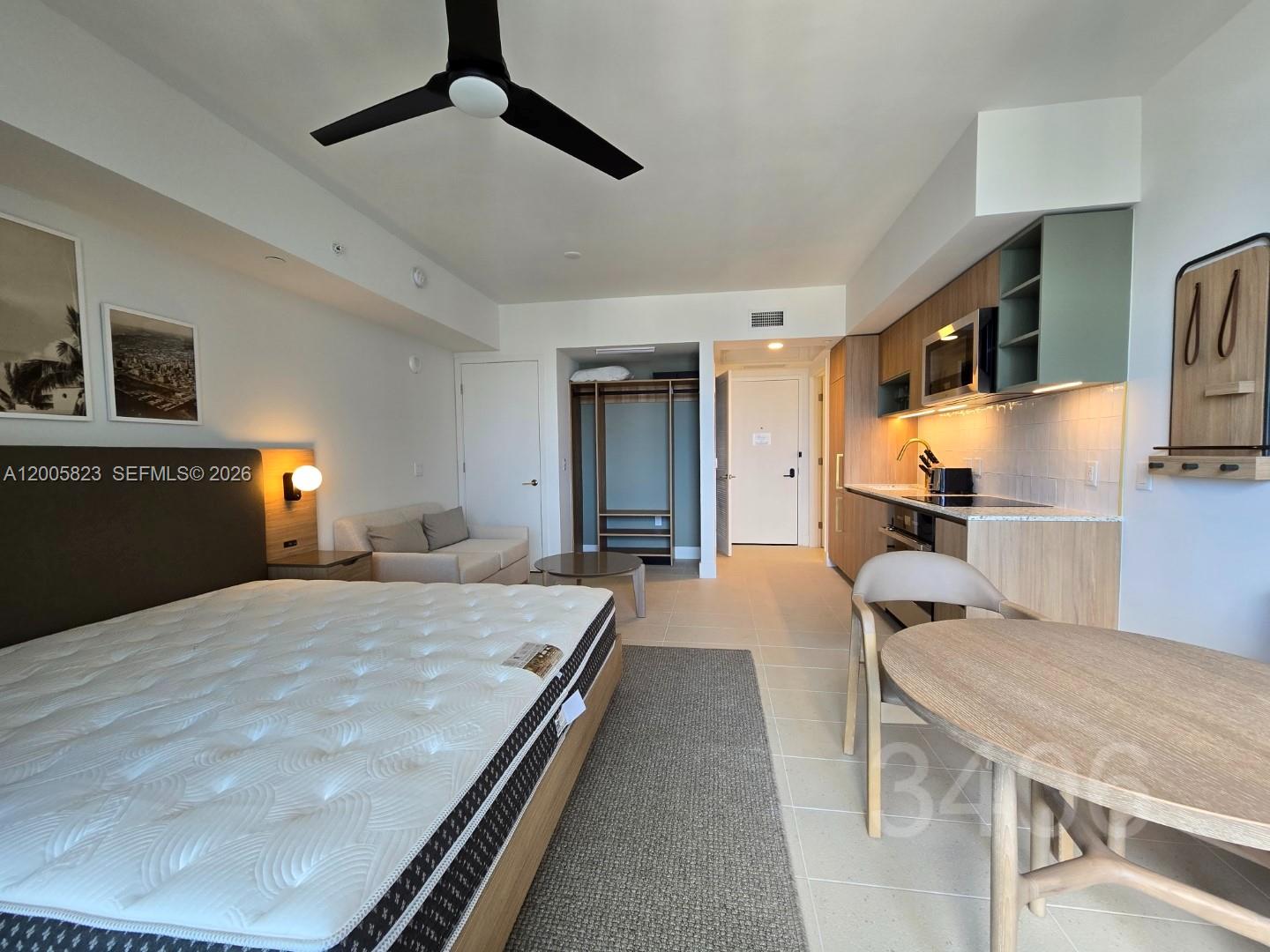 A studio apartment features a bed, kitchenette, dining table, and open closet area — 601 NE 1 Ave # 3406, Miami FL 33132, MIAMI, FL