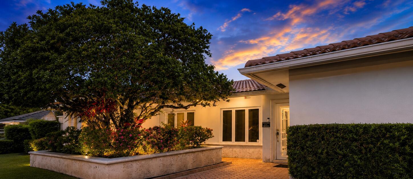 A white house exterior features a large tree, a stone planter, and a paved walkway — 4220 NE 26th Avenue, Lighthouse Point FL 33064, LIGHTHOUSE POINT, FL