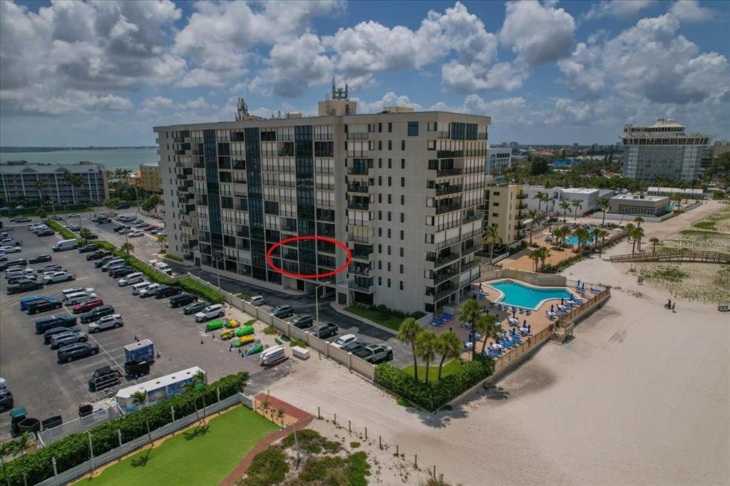 An aerial view shows a multi-story beachfront condominium building with a red-circled balcony — 5396 GULF BOULEVARD UNIT 304, ST PETE BEACH, FL