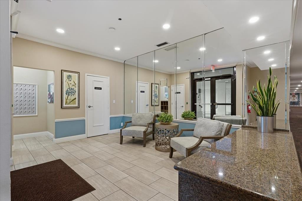 An aerial view of a multi-story condominium building with a red circle highlighting a balcony — 5396 GULF BOULEVARD UNIT 304, ST PETE BEACH, FL