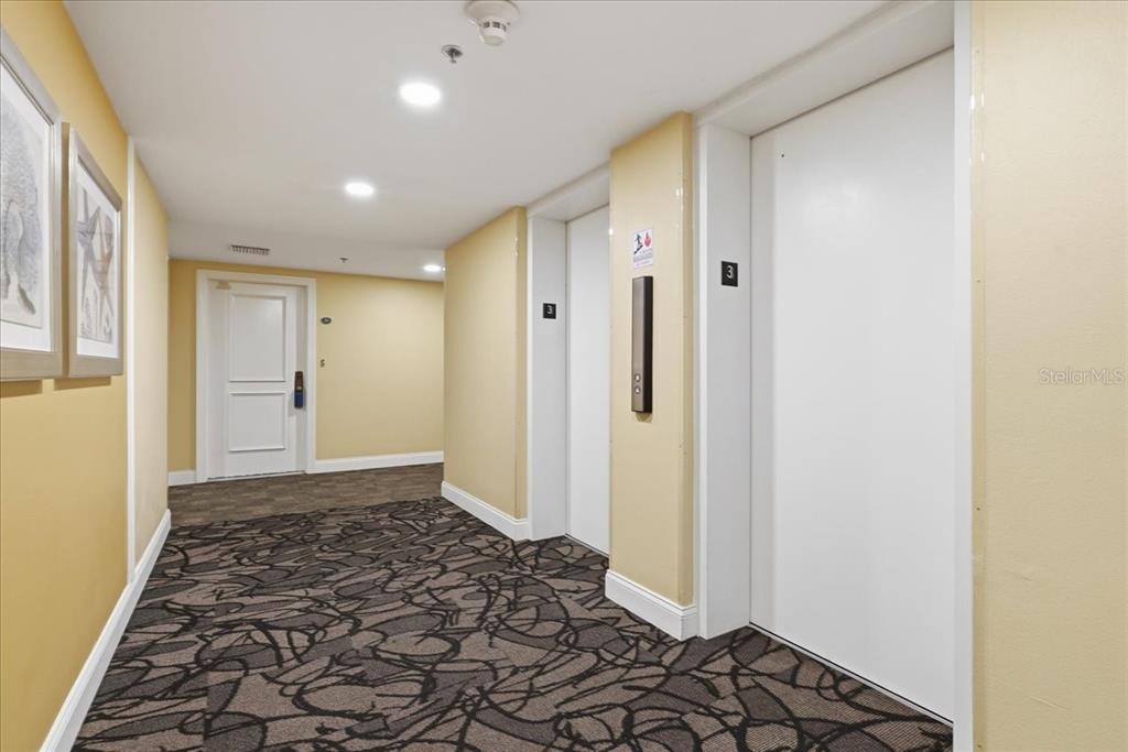 A lobby area features tiled floors, mirrored walls, two armchairs, and a granite-topped counter — 5396 GULF BOULEVARD UNIT 304, ST PETE BEACH, FL