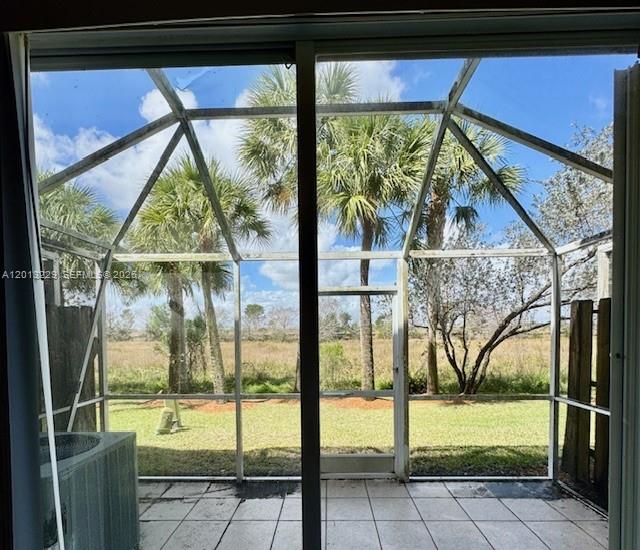 A view from inside looking out through a sliding glass door to a screened patio — 2567 Cordoba Bnd, Weston FL 33327, WESTON, FL