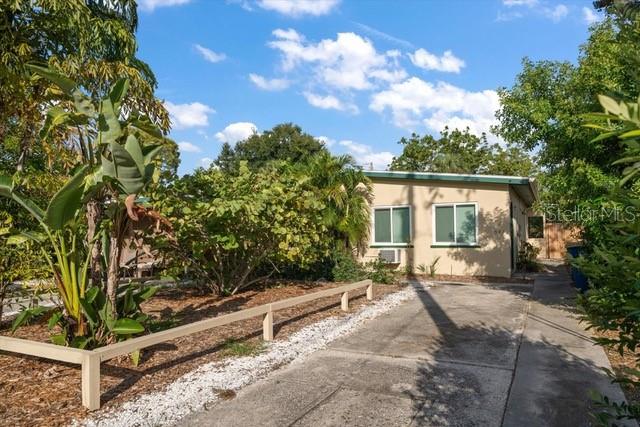A single-story house with a concrete driveway and a wooden fence in the front yard — 533 YELVINGTON AVENUE, CLEARWATER, FL