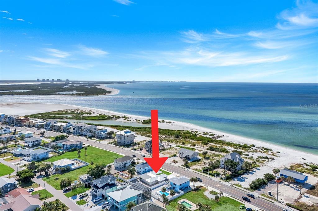 An aerial view shows a coastal beach house with a pool near the ocean — 7987 ESTERO BOULEVARD, FORT MYERS BEACH, FL