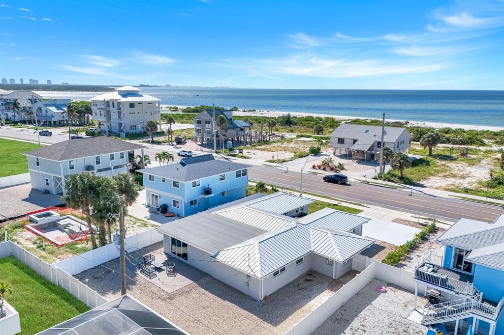 An aerial view shows several coastal houses near a beach and a blue ocean — 7987 ESTERO BOULEVARD, FORT MYERS BEACH, FL