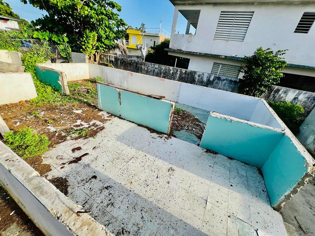 An outdoor area features a tiled patio enclosed by low, light blue concrete walls — 225 RUÍZ BELVIS, SAN JUAN, PR