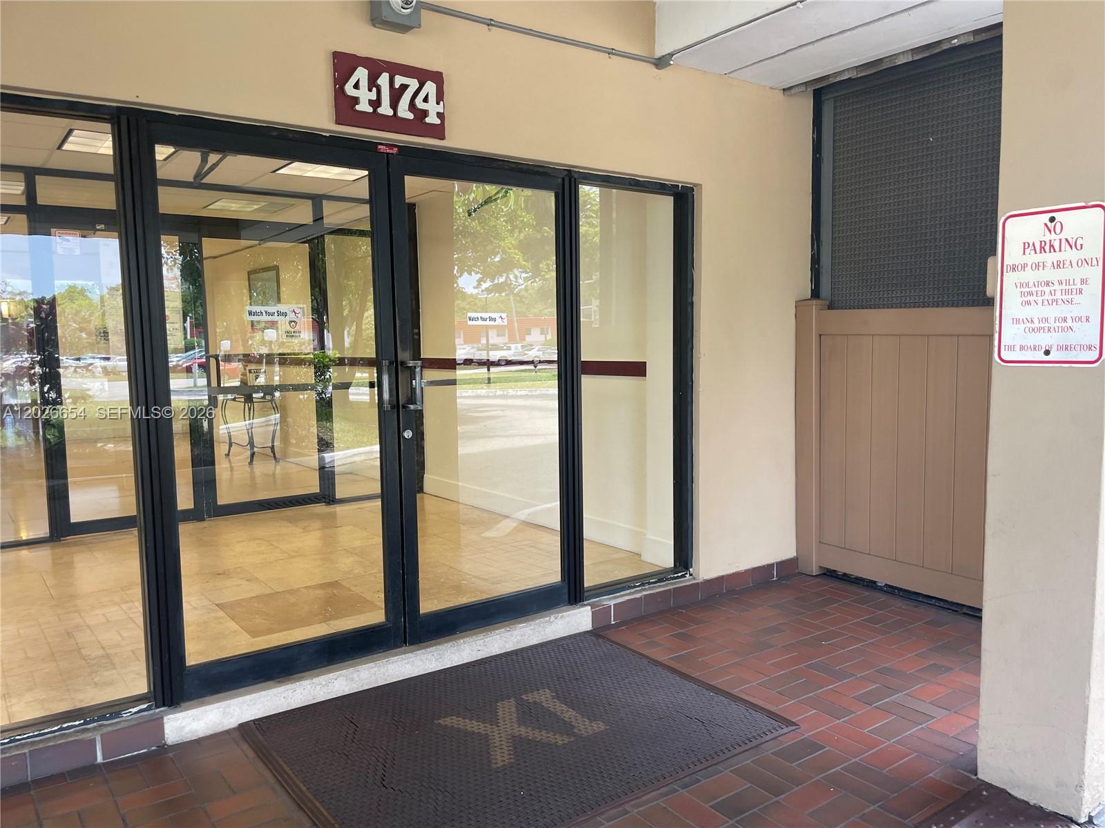 The exterior entrance features glass double doors, a brick floor, and a no parking sign — 4174 Inverrary Dr # 903, Lauderhill FL 33319, LAUDERHILL, FL