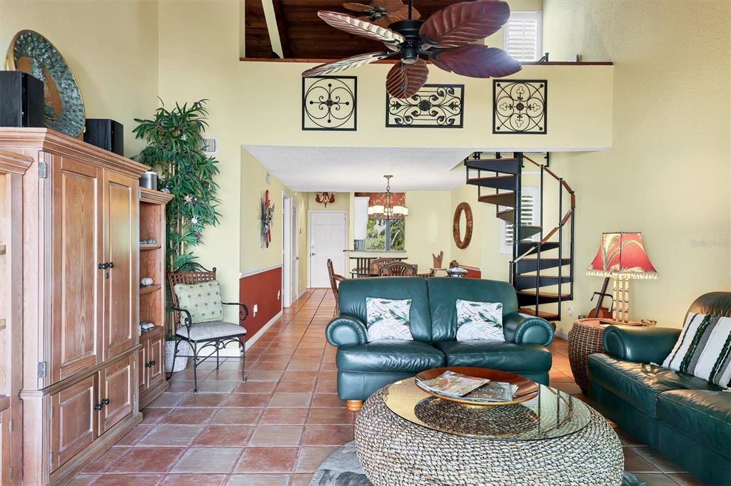 A living room features tile floors, a spiral staircase, and a ceiling fan — 5270 GULF OF MEXICO DRIVE UNIT 508, LONGBOAT KEY, FL