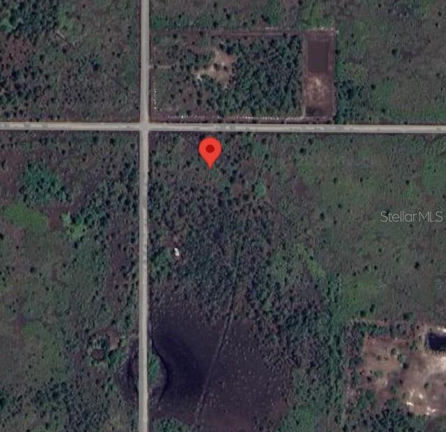 This is an aerial map view of a vacant, wooded lot with a red location pin — 50648 BERMONT ROAD, PUNTA GORDA, FL