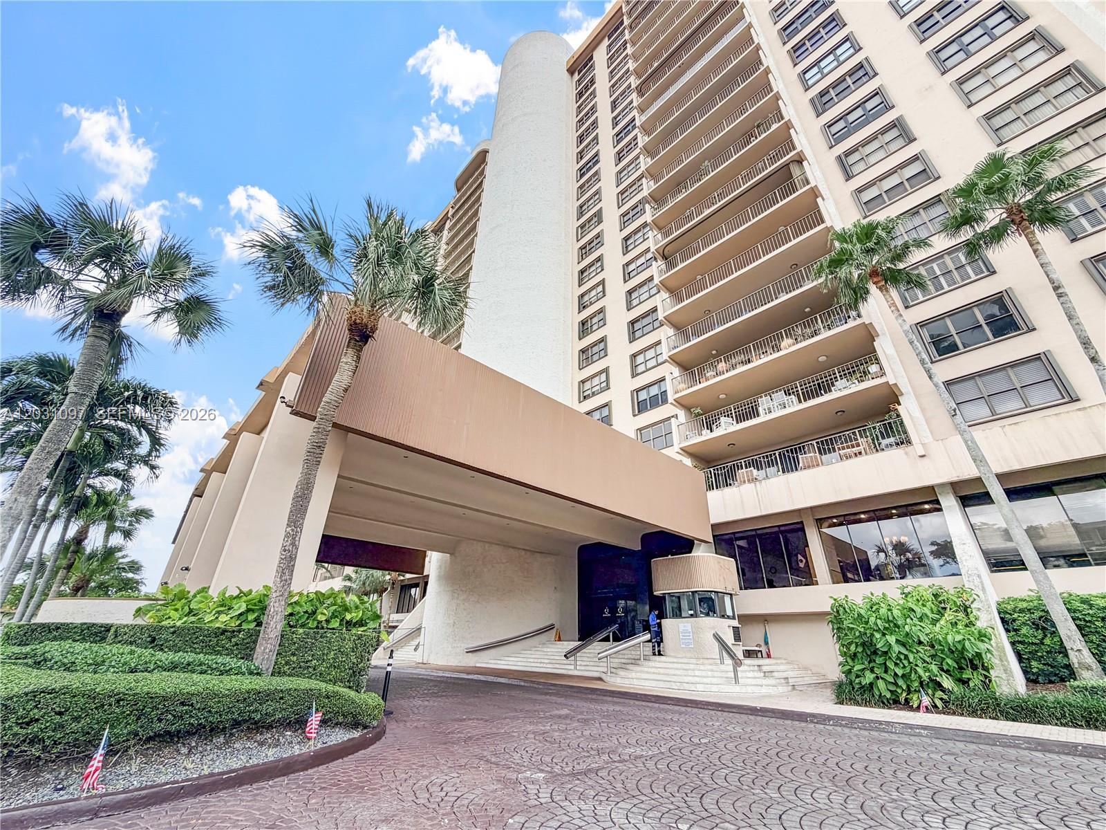 A multi-story residential building features a covered entrance, balconies, and palm trees — 1800 NE 114th St # 1607, Miami FL 33181, MIAMI, FL