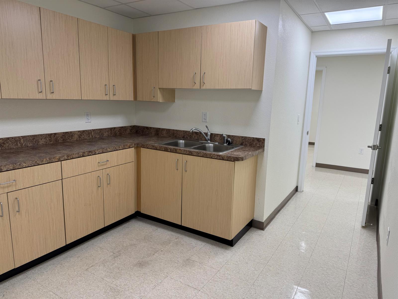 A kitchenette features light wood cabinets, a brown laminate countertop, and a double sink — 3205 Medical Way, Sebring FL 33870, SEBRING, FL