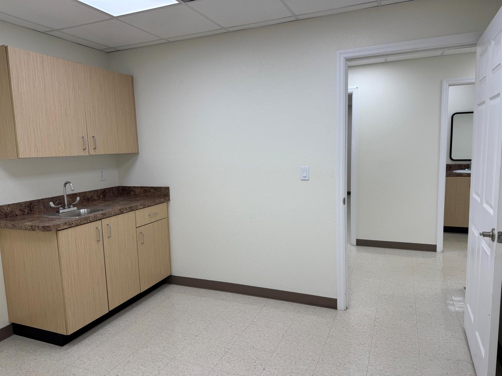 A small room features light wood cabinetry, a sink, and a doorway leading to another room — 3205 Medical Way, Sebring FL 33870, SEBRING, FL