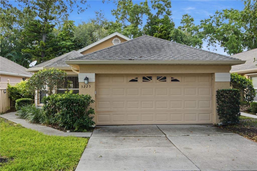 A tan single-story house features a two-car garage and a concrete driveway — 3225 GULF WATCH COURT, SARASOTA, FL