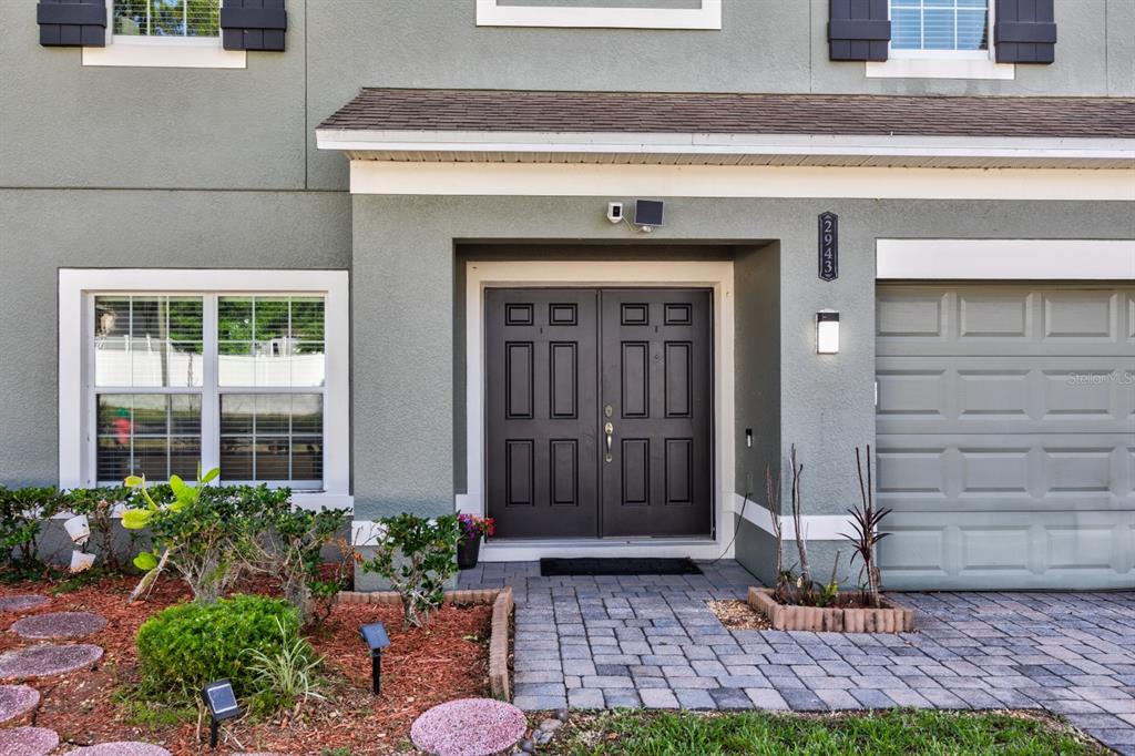 The exterior of a two-story home features a double front door and a garage — 2943 ETOWAH PARK BOULEVARD, TAVARES, FL