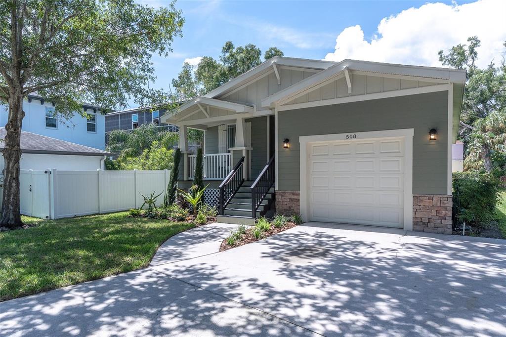 A single-story house with a green exterior, a front porch, and a one-car garage — 508 WASHINGTON AVENUE, OLDSMAR, FL