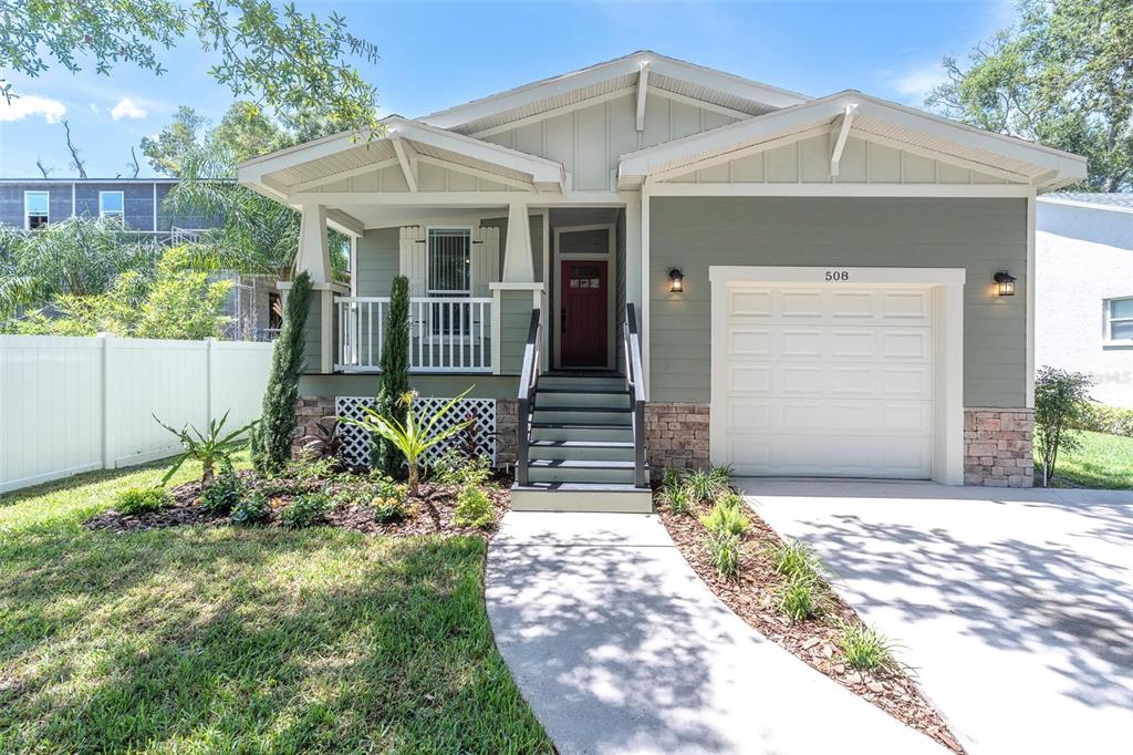 A one-story house with green siding, a front porch, and a single-car garage — 508 WASHINGTON AVENUE, OLDSMAR, FL