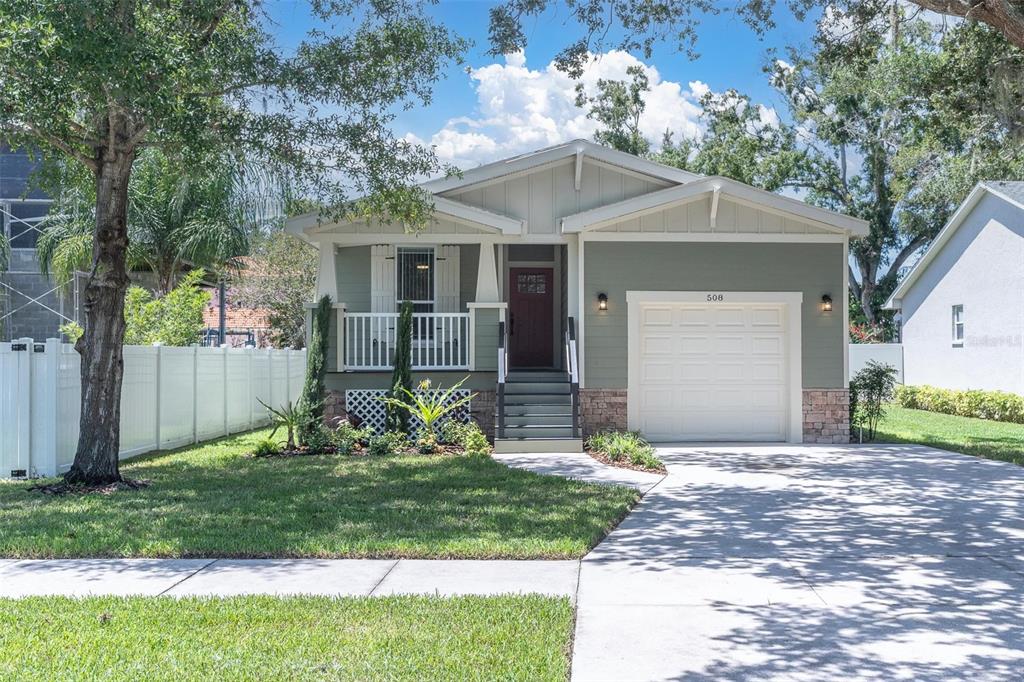 A single-story house with green siding, a front porch, and an attached one-car garage — 508 WASHINGTON AVENUE, OLDSMAR, FL