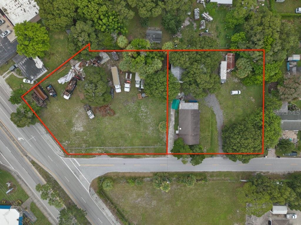 An aerial view shows two adjacent lots with a house, several vehicles, and mature trees — 711 S 21ST STREET, FORT PIERCE, FL
