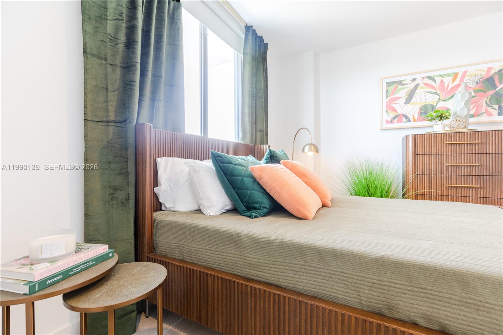 A bedroom features a slatted wood bed frame, green velvet curtains, and a wooden dresser — 1005 Spring Garden Rd # 530, Miami FL 33136, MIAMI, FL