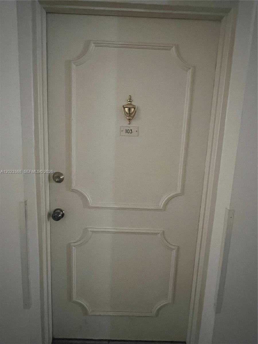 A white door with a brass knocker and the number 103 is set in a frame — 2060 NW 48th Ter # 103, Lauderhill FL 33313, LAUDERHILL, FL