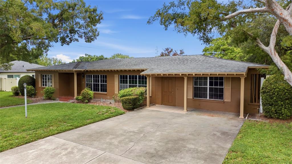 A single-story house with a brown exterior, a concrete driveway, and a covered front entrance — 808 N MACDILL AVENUE, TAMPA, FL