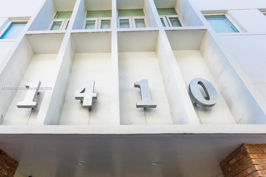 The exterior of a building features the large metal house numbers 1410 mounted on white pillars — 1410 20th St # 1418, Miami Beach FL 33139, MIAMI BEACH, FL