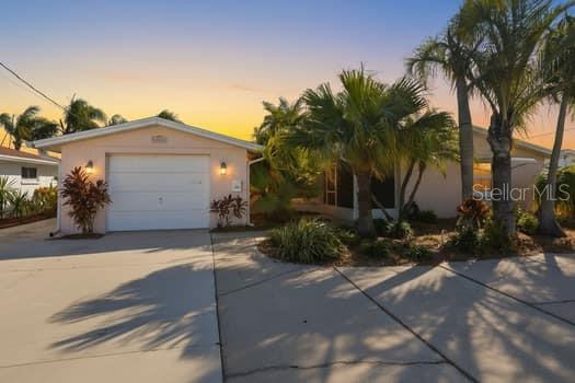 An aerial view shows a waterfront house with a boat dock and canal access — 12612 4TH ISLE, HUDSON, FL