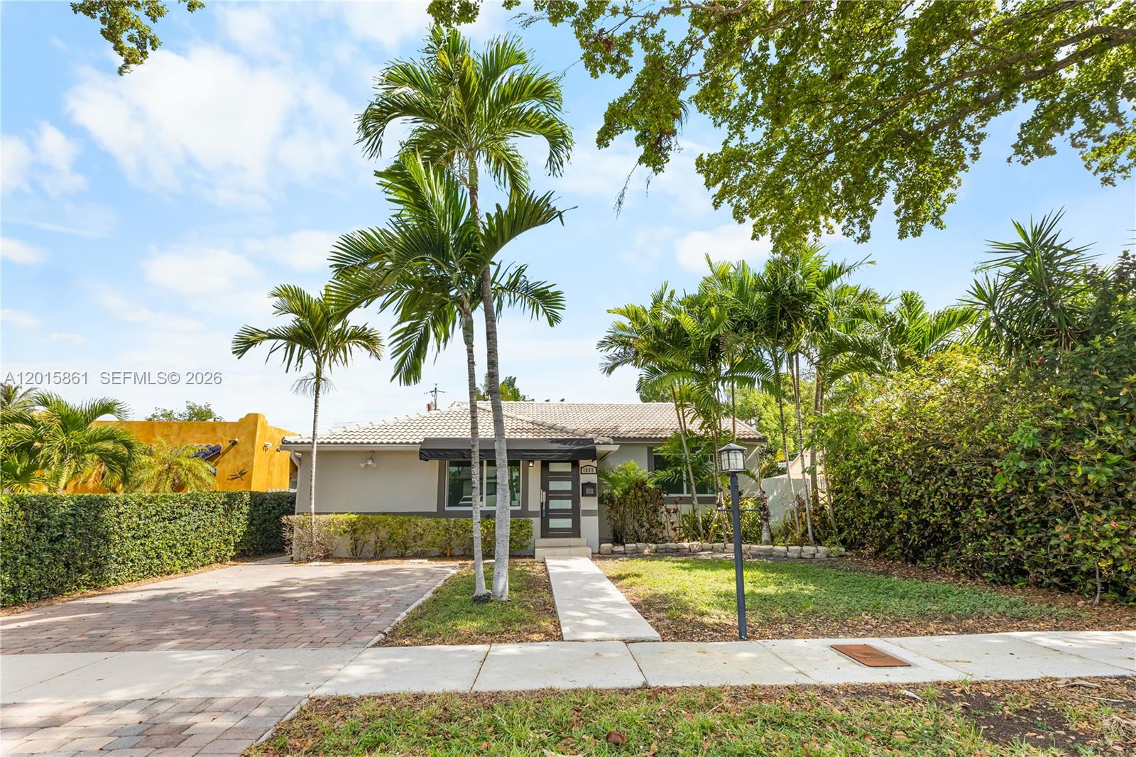 A single-story house features a paved driveway, palm trees, and a tiled roof — 1835 SW 18th St, Miami FL 33145, MIAMI, FL