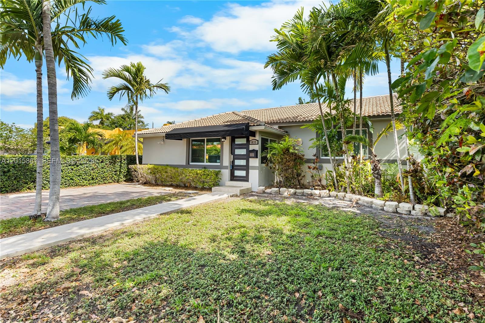 A single-story house with a tiled roof, palm trees, and a paved driveway — 1835 SW 18th St, Miami FL 33145, MIAMI, FL