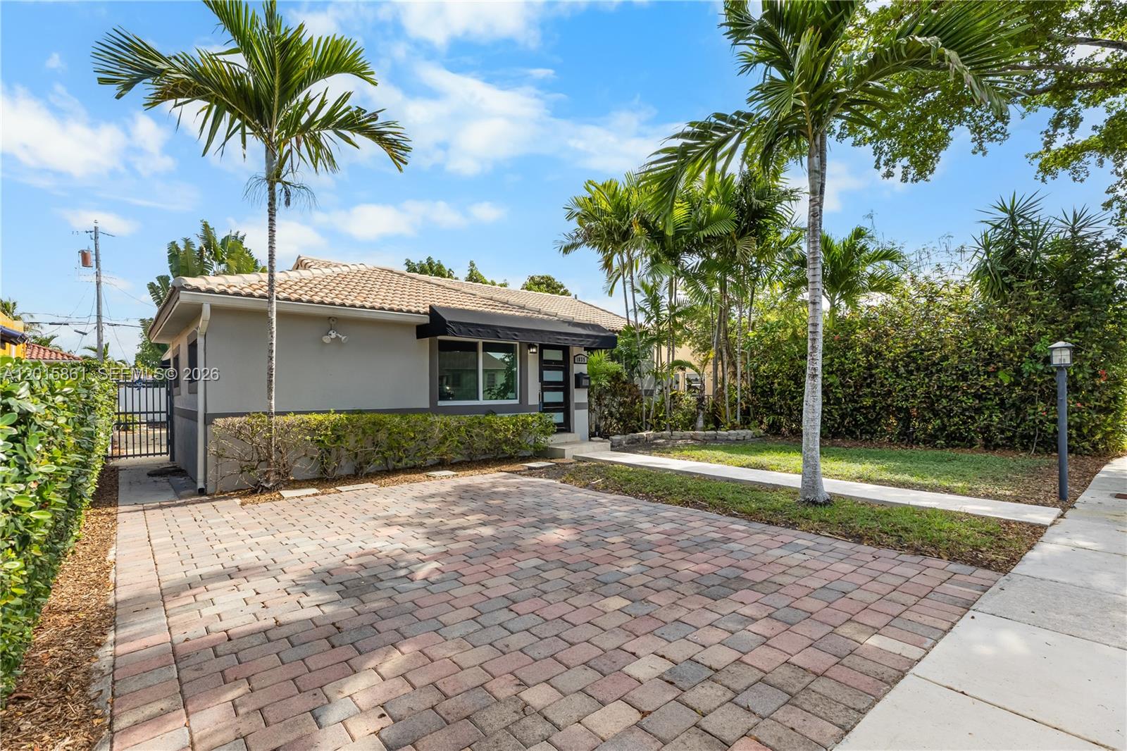 A single-story house with a paved driveway, palm trees, and a tiled roof — 1835 SW 18th St, Miami FL 33145, MIAMI, FL