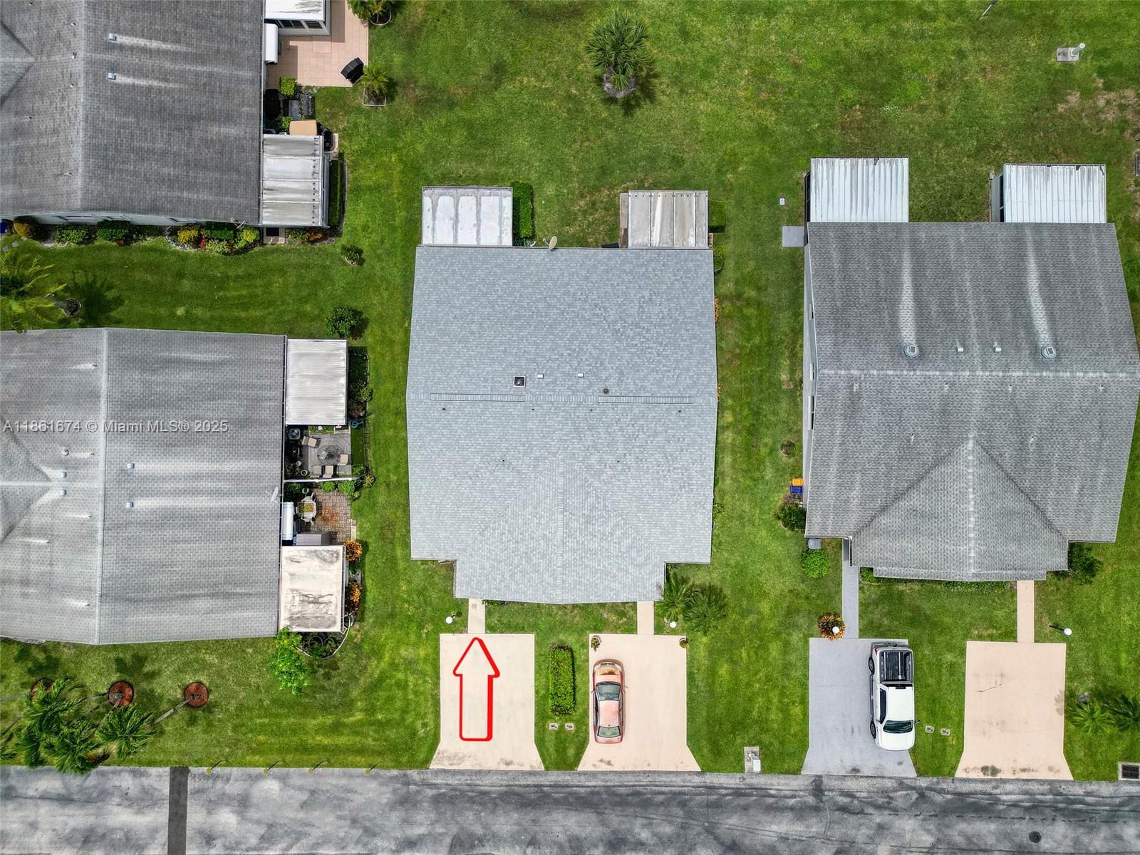 An aerial view shows a residential house with a driveway and a red arrow — 3319 Americo Dr, West Palm Beach FL 33417, WEST PALM BEACH, FL