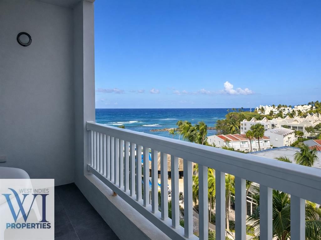 A balcony with a white railing overlooks the ocean and a coastal resort complex — 201 DORADO DEL MAR BLVD UNIT 2656, DORADO, PR