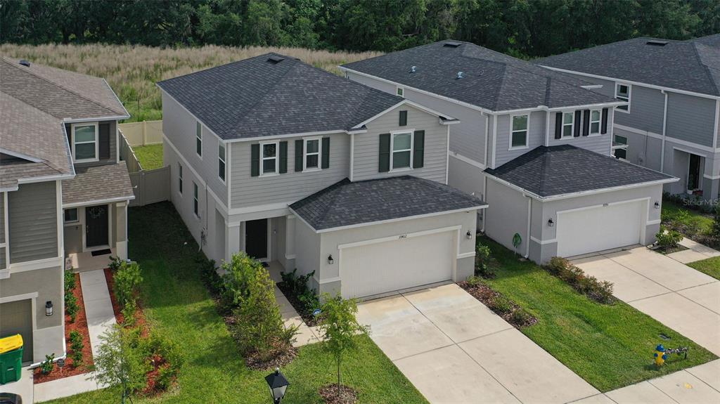 An elevated exterior view of a two-story suburban house with a two-car garage — 37402 YUKON DRIVE, ZEPHYRHILLS, FL