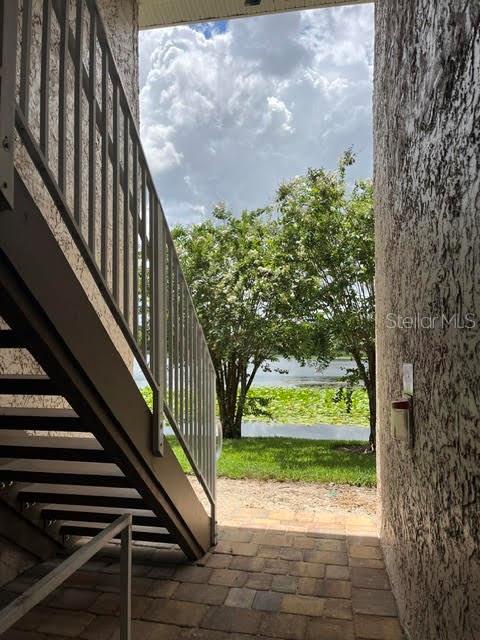 A view from a covered patio looking out at a lake through a staircase — 145 N PEARL LAKE CAUSEWAY UNIT 204, ALTAMONTE SPRINGS, FL